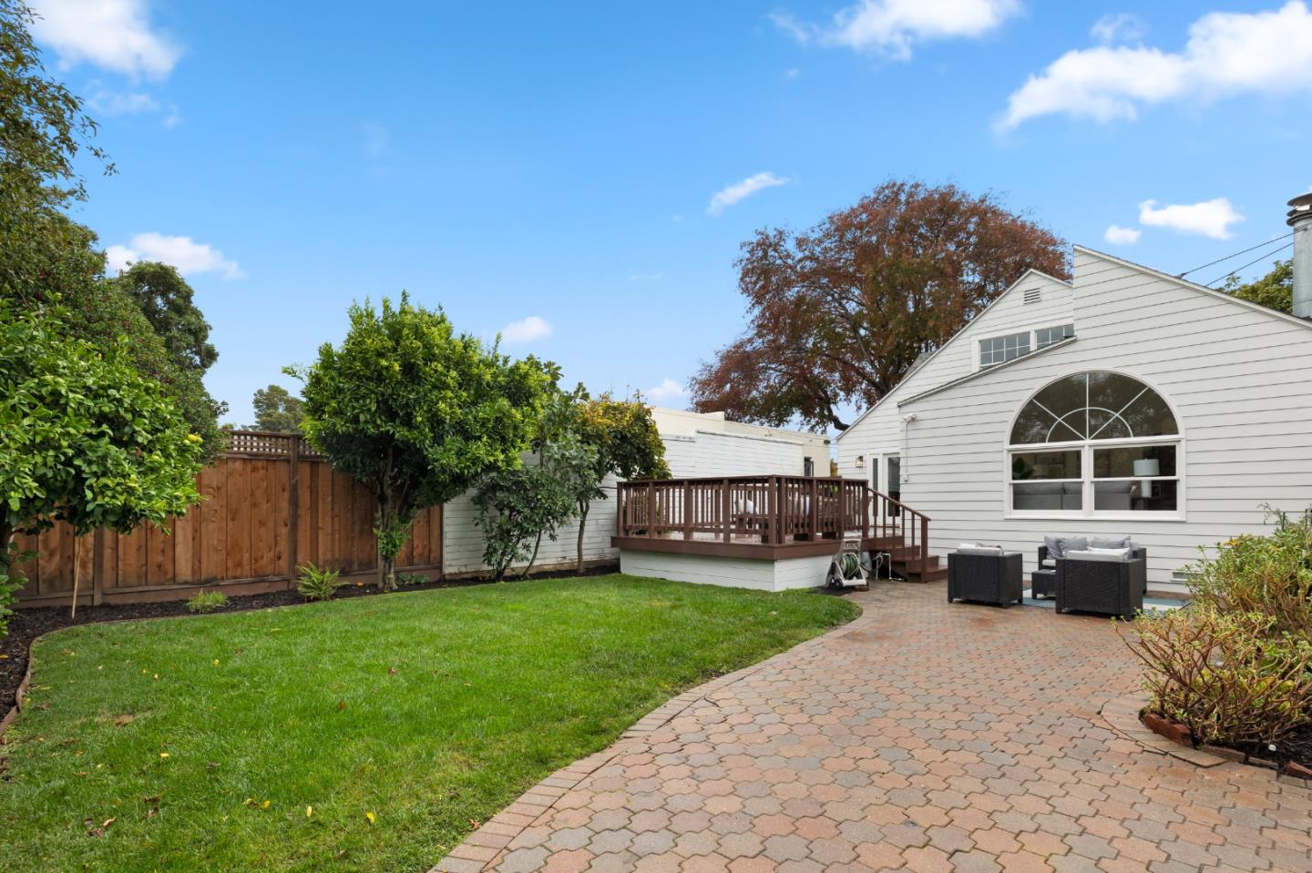 220 Channing Road Burlingame, CA 94010 - Photo 57 of 60 a view of a white house with a yard plants and large tree
