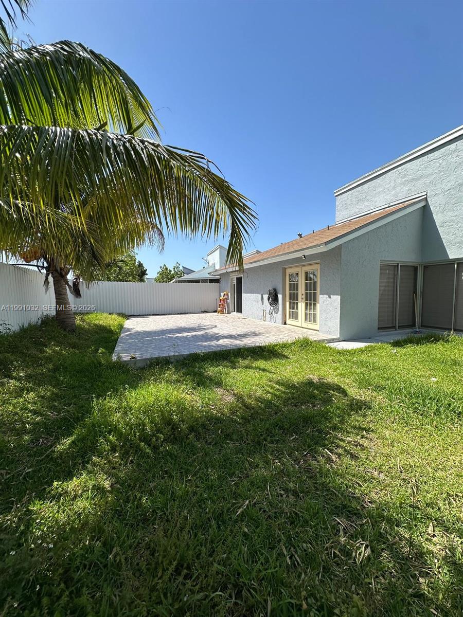 20926 Southwest 124th Ave Road Miami, FL 33177 - Photo 1 of 10 a front view of house with yard and green space