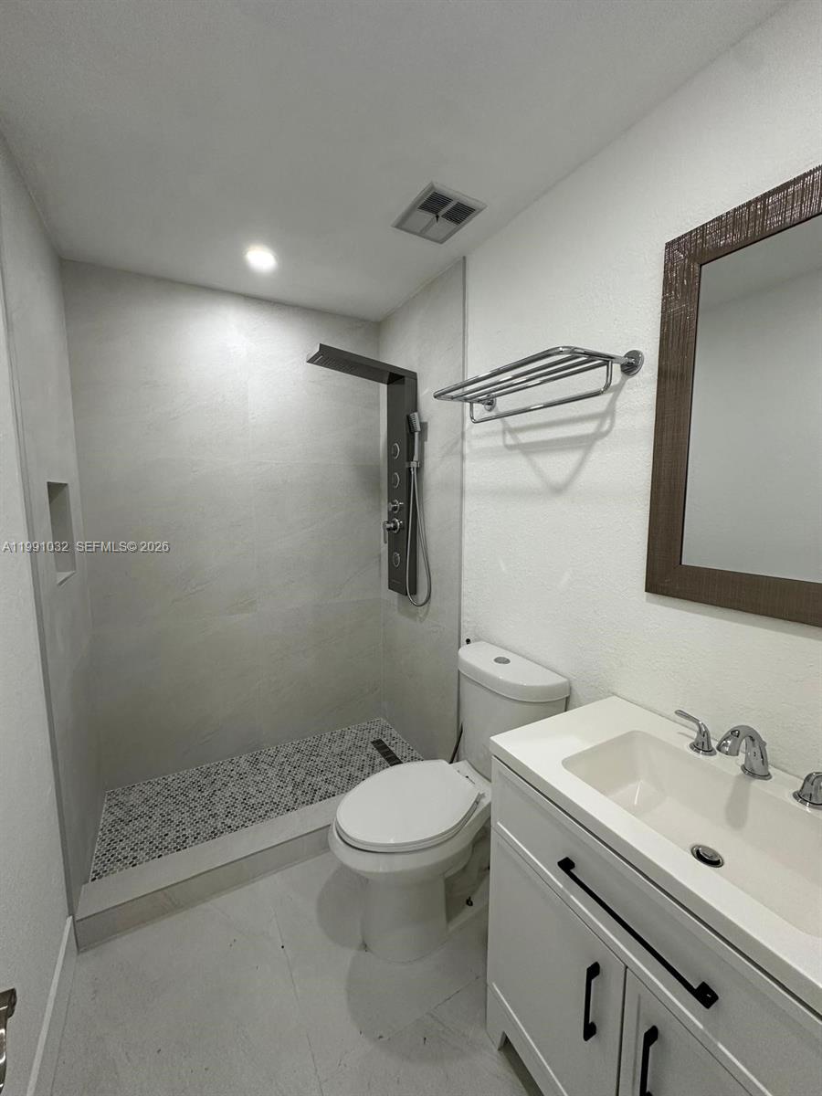 20926 Southwest 124th Ave Road Miami, FL 33177 - Photo 4 of 10 a bathroom with a sink a toilet and shower