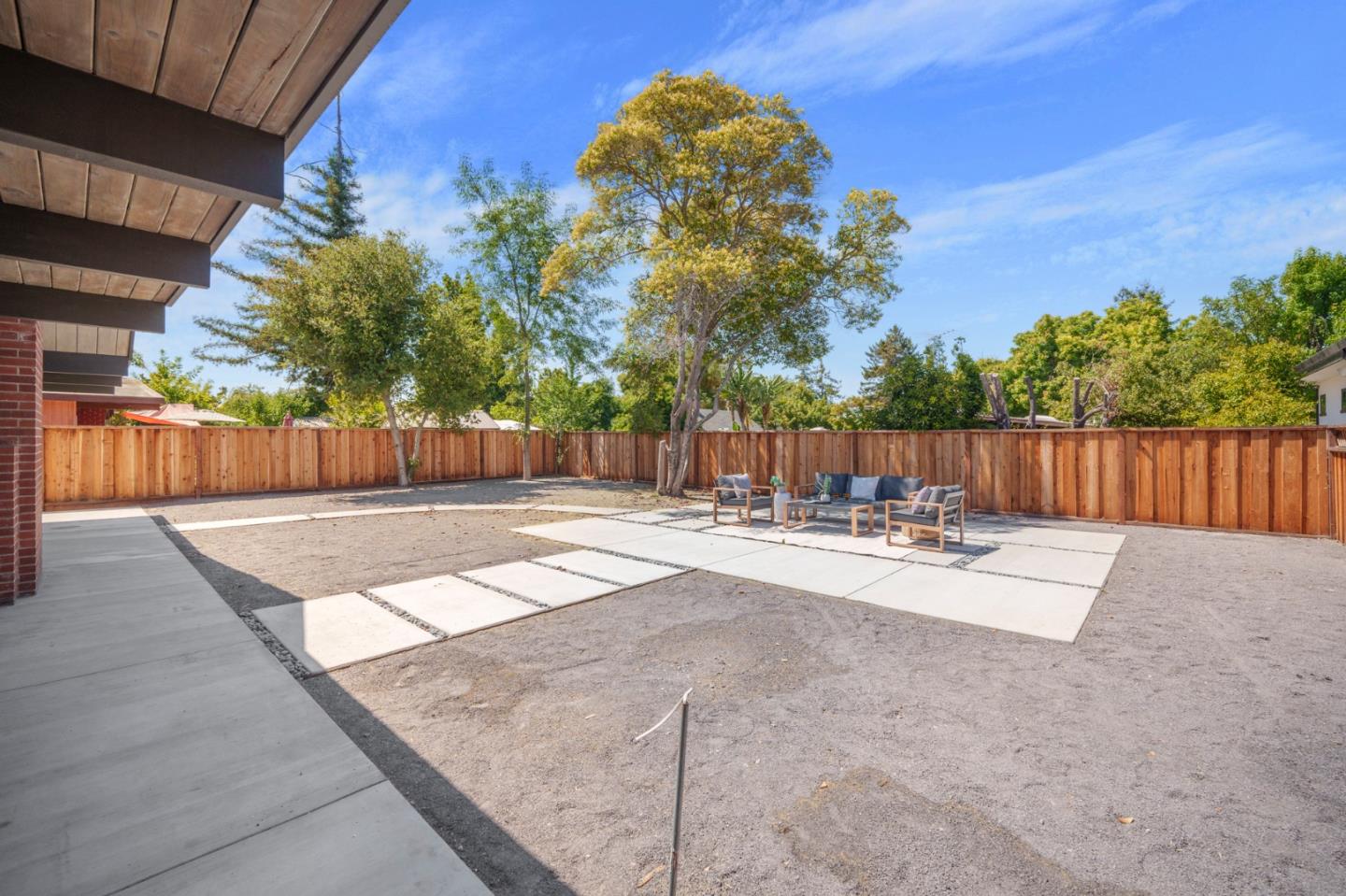 1111 East Homestead Road Sunnyvale, CA 94087 - Photo 20 of 25 a view of a backyard with table and chairs and wooden fence