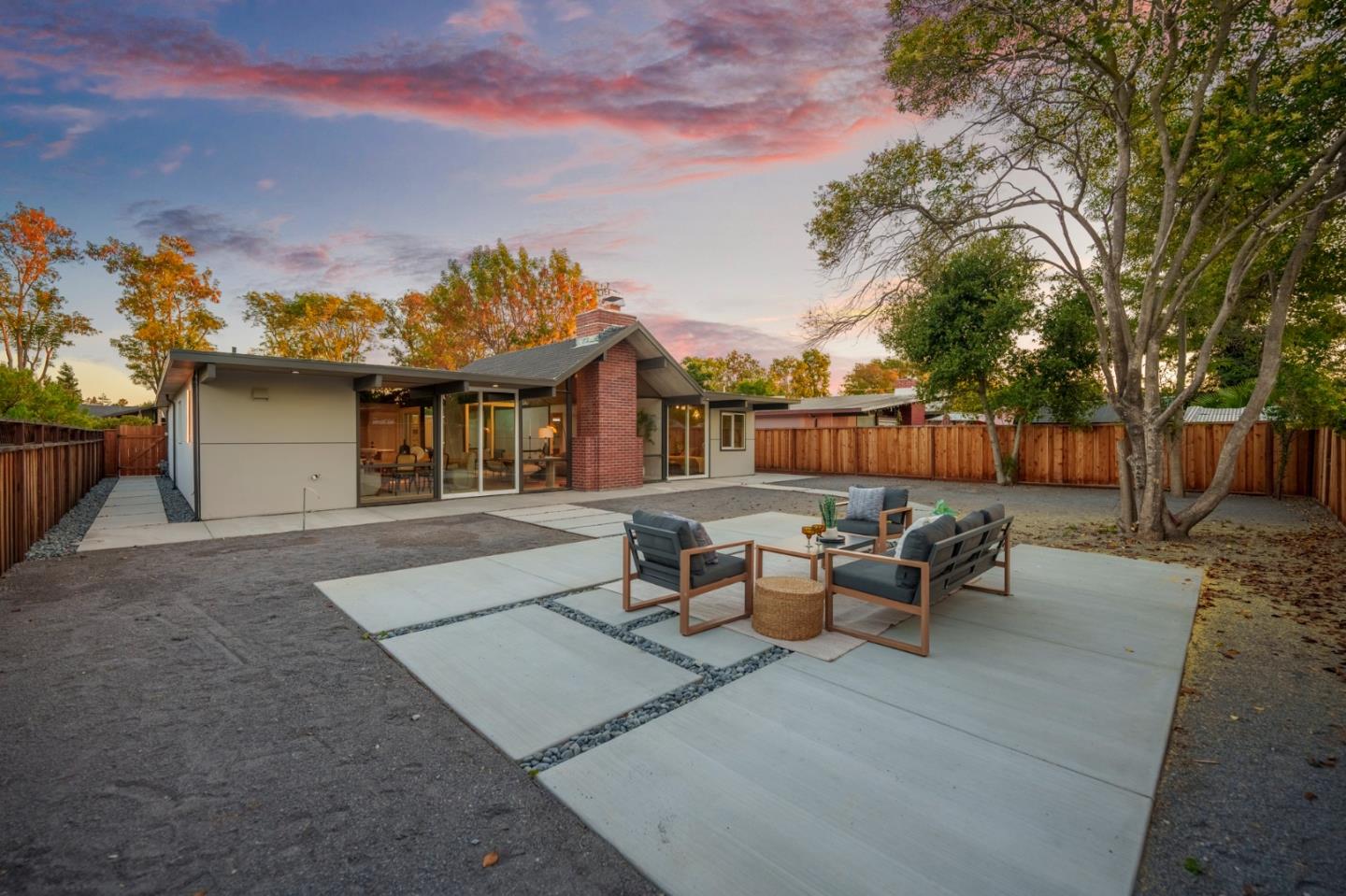 1111 East Homestead Road Sunnyvale, CA 94087 - Photo 23 of 25 a view of a patio with couches and table and chairs and wooden fence