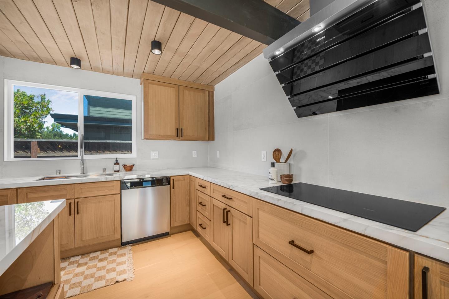 1111 East Homestead Road Sunnyvale, CA 94087 - Photo 4 of 25 a kitchen with granite countertop cabinets stainless steel appliances a sink and a window