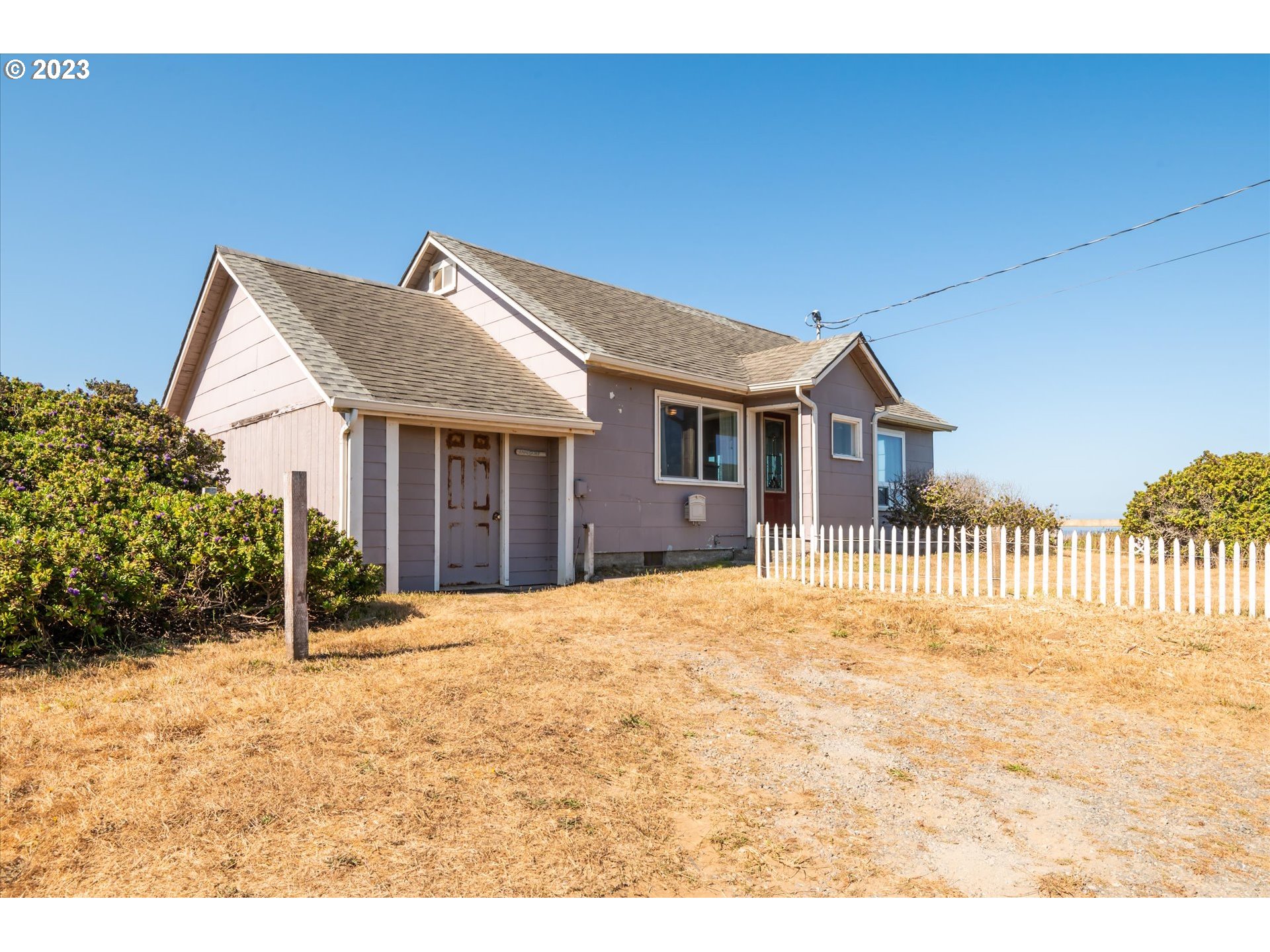 33032 Nesika Road Gold Beach, OR 97444 - Photo 16 of 35 a front view of a house with a garden
