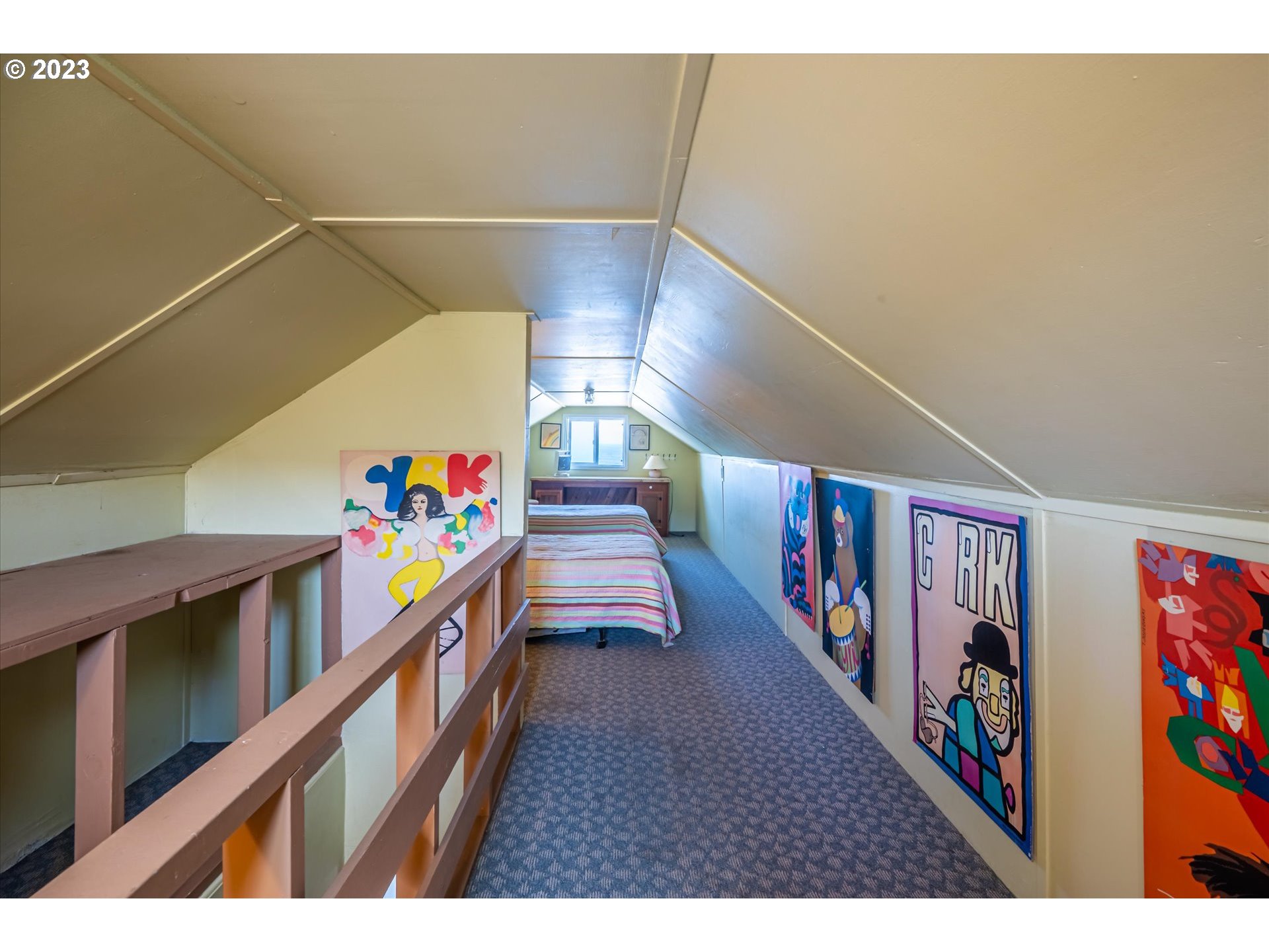 33032 Nesika Road Gold Beach, OR 97444 - Photo 25 of 35 a hallway with beautiful frames and toys