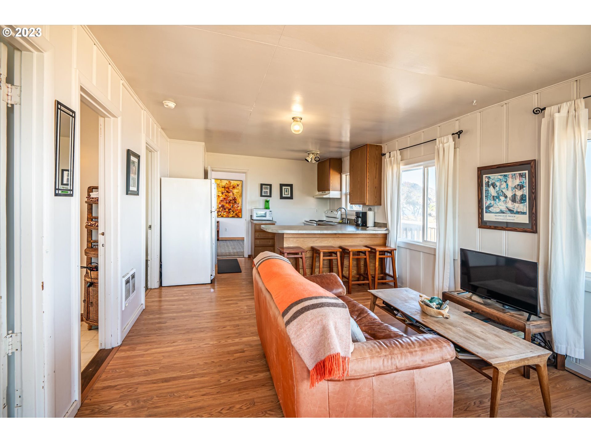 33032 Nesika Road Gold Beach, OR 97444 - Photo 3 of 35 a living room with furniture and a flat screen tv