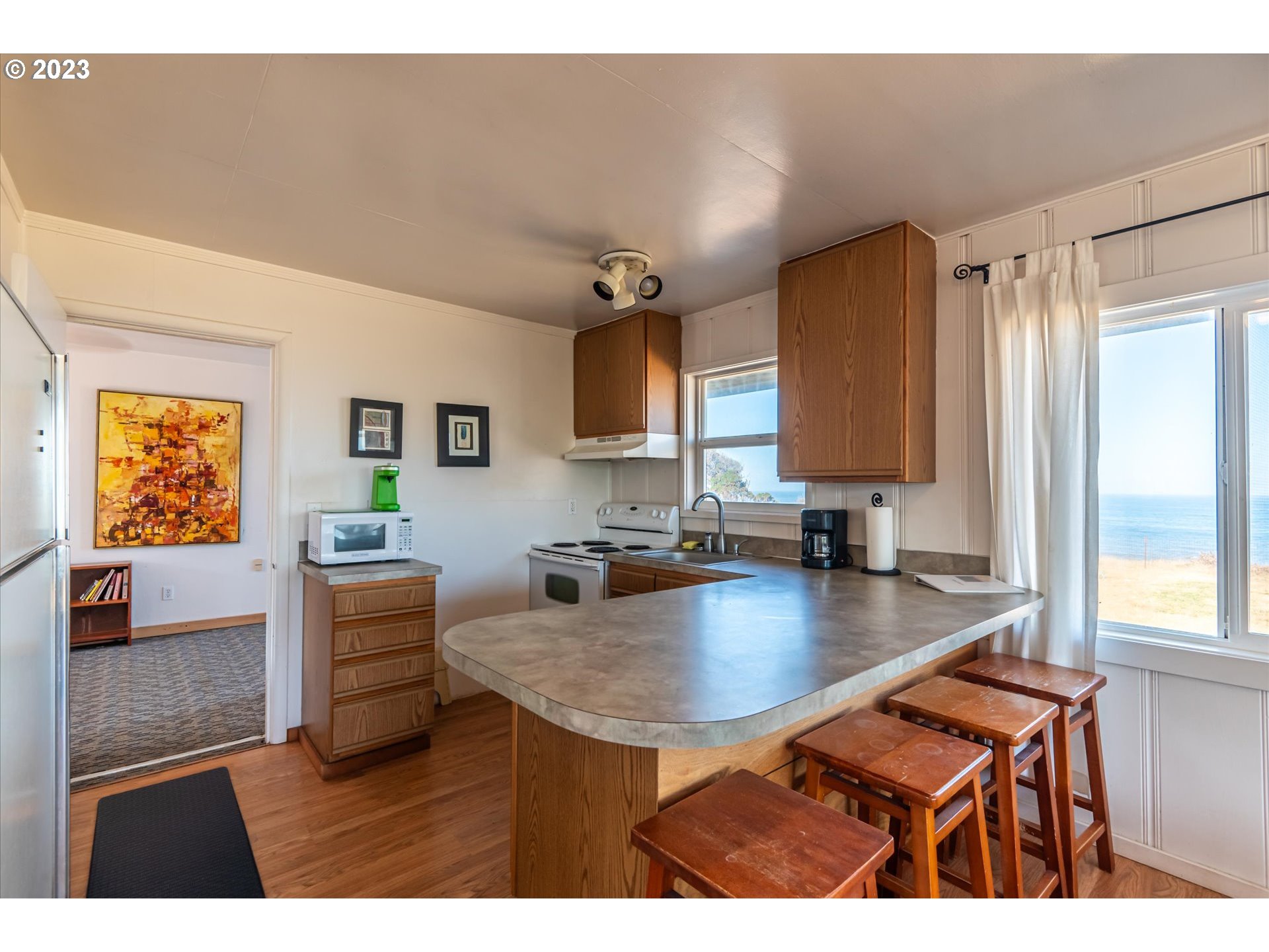 33032 Nesika Road Gold Beach, OR 97444 - Photo 6 of 35 a kitchen with a sink cabinets and window