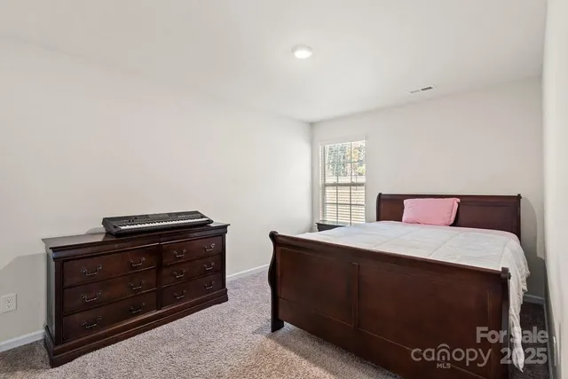 a bedroom with a bed and dresser