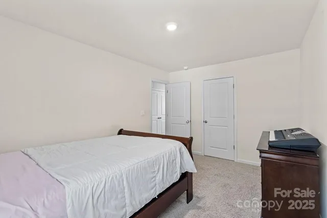 a bedroom with a bed and a ceiling fan