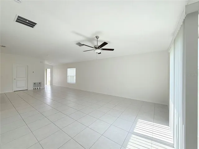 an empty room with closet and windows