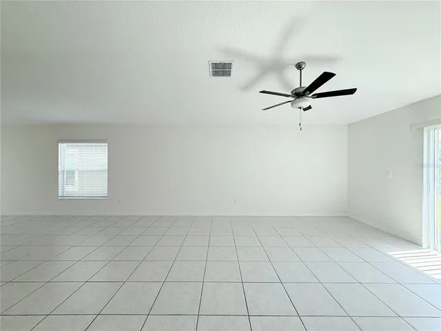 a view of an empty room and a window