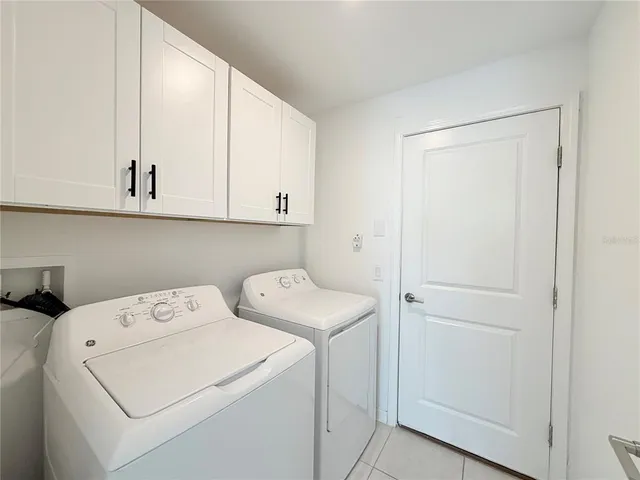 a view of storage and utility room with washer and dryer