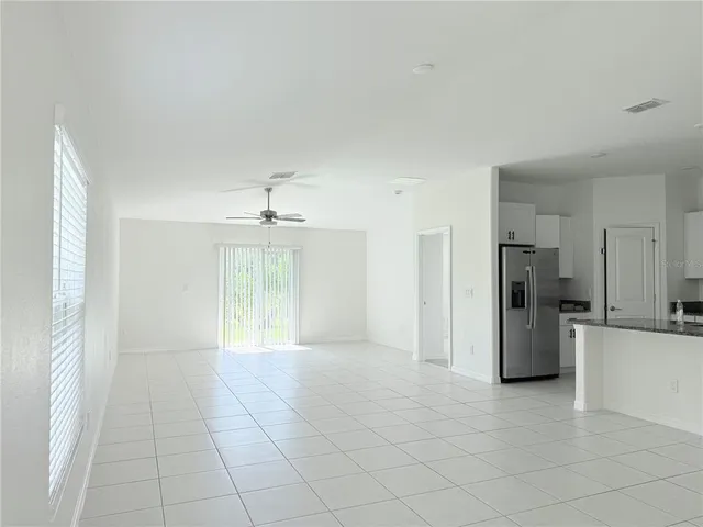 a view of an empty room with a kitchen