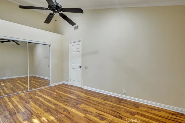 a bedroom with a bed and a chandelier fan