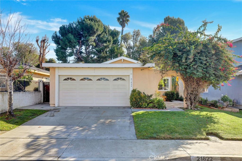 21822 Jinetes Mission Viejo, CA 92691 - Photo 2 of 33 a front view of a house with a yard and garage
