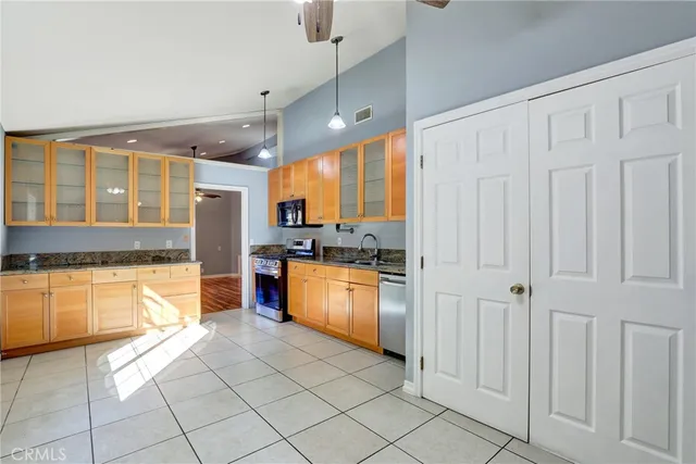a large kitchen with stainless steel appliances lots of counter top space