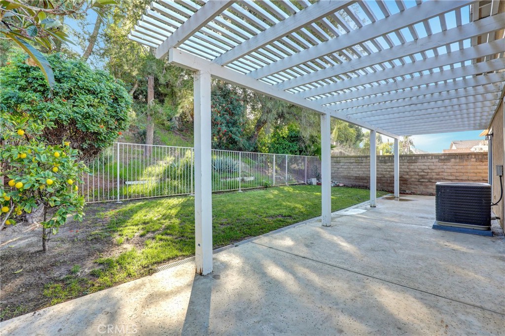 21822 Jinetes Mission Viejo, CA 92691 - Photo 28 of 33 a view of a backyard with floor to ceiling window and wooden fence