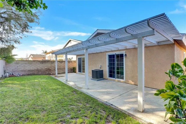 a view of a backyard with plants and large trees