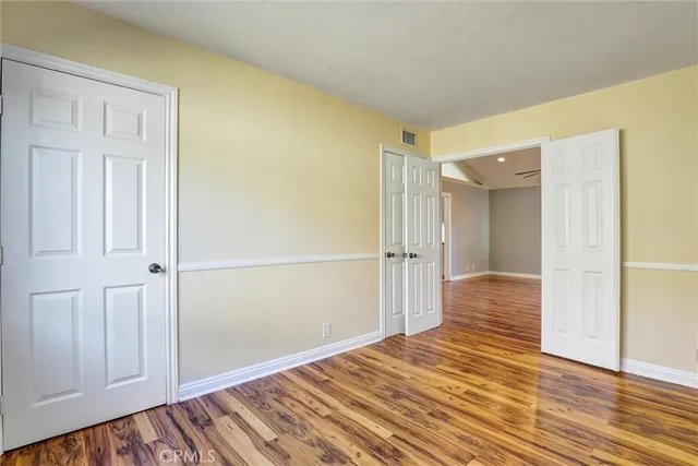 a view of a room with wooden floor
