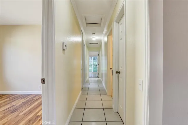 a view of a hallway with wooden floor and closet