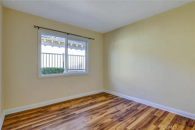 a view of a room with wooden floor and windows