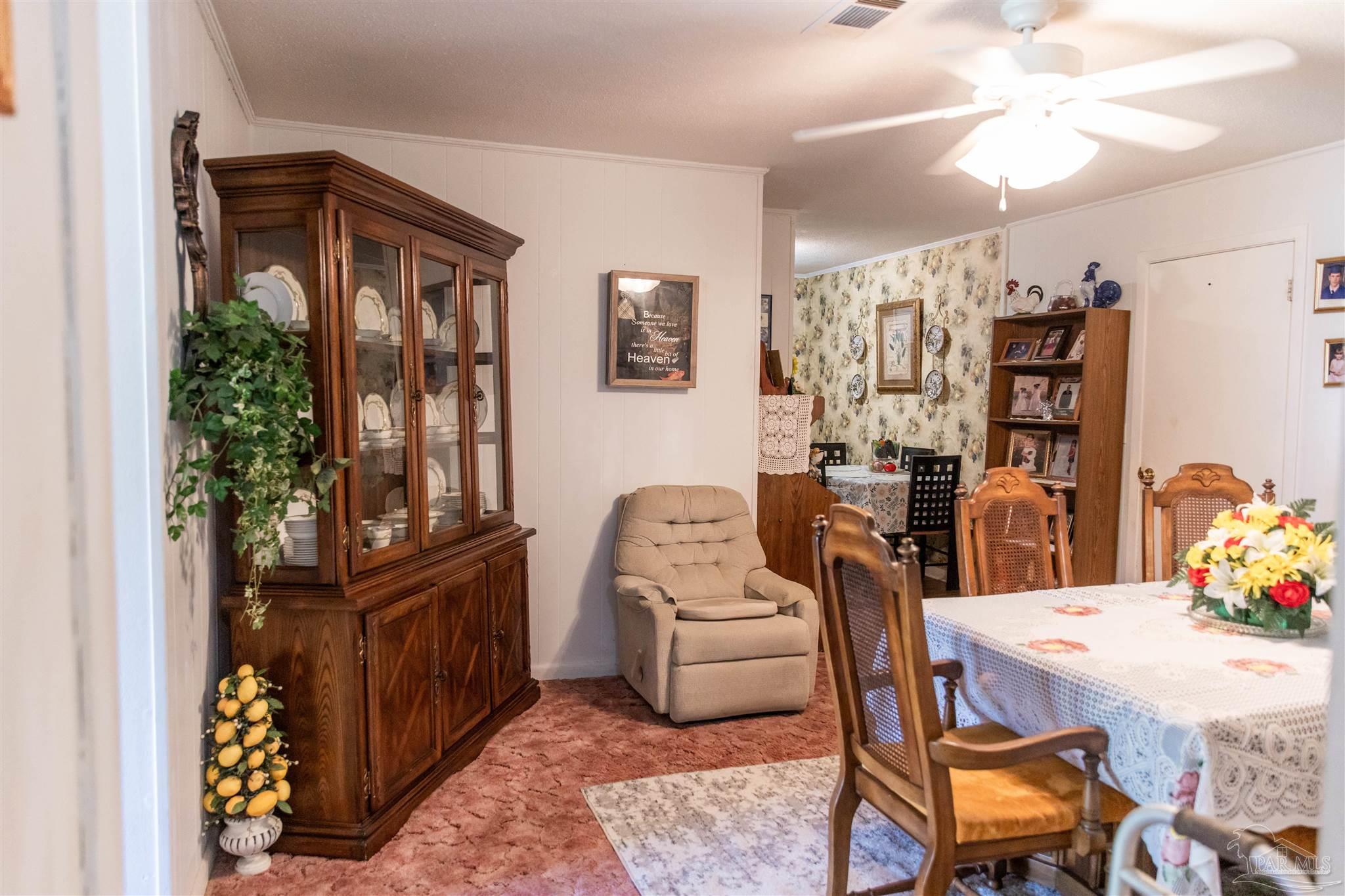 7569 Pine Meadows Loop Milton, FL 32571 - Photo 14 of 25 a living room with furniture and a potted plant