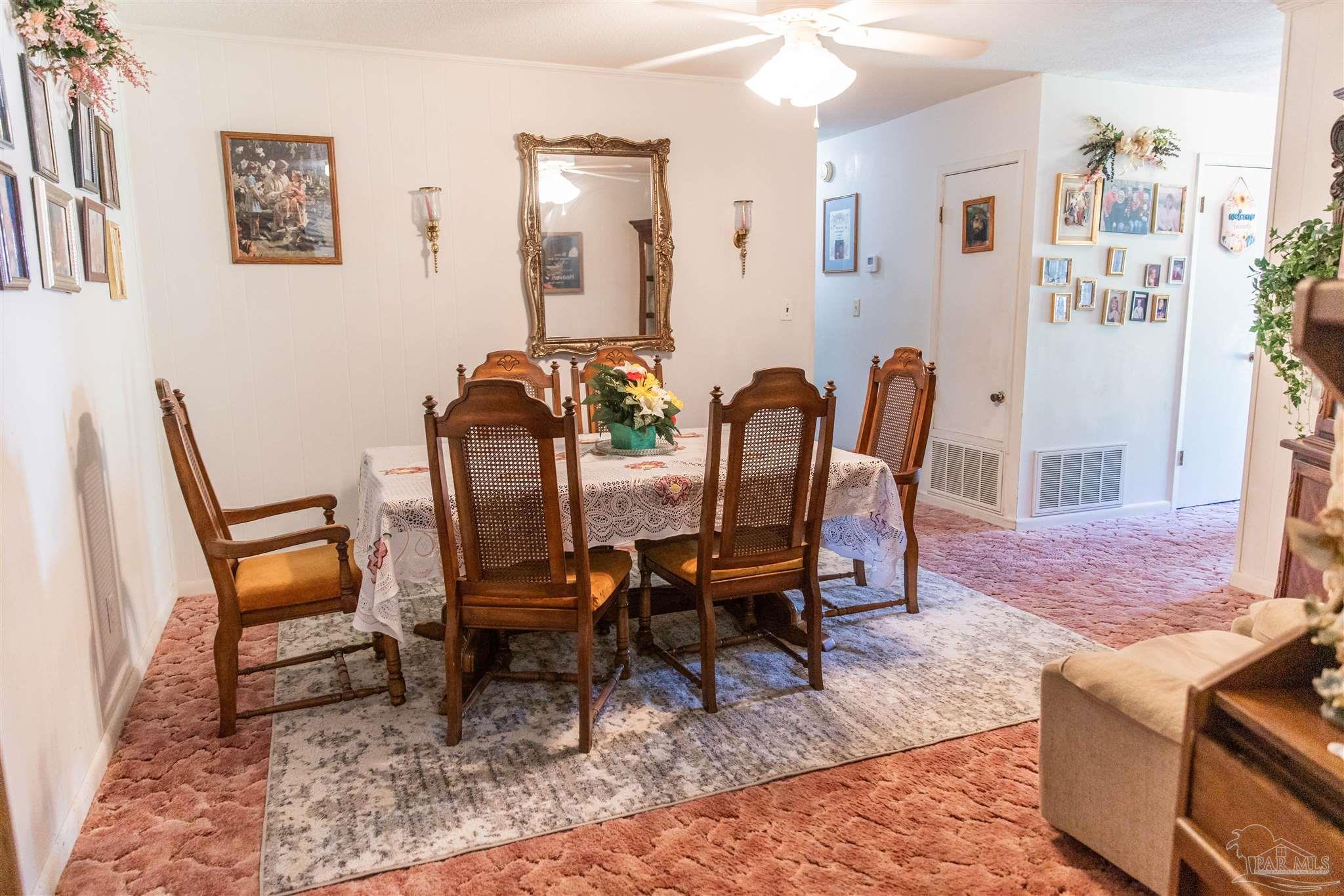 7569 Pine Meadows Loop Milton, FL 32571 - Photo 17 of 25 a view of a dining room with furniture