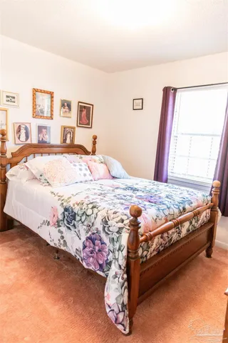 a bed sitting in a bedroom next to a window