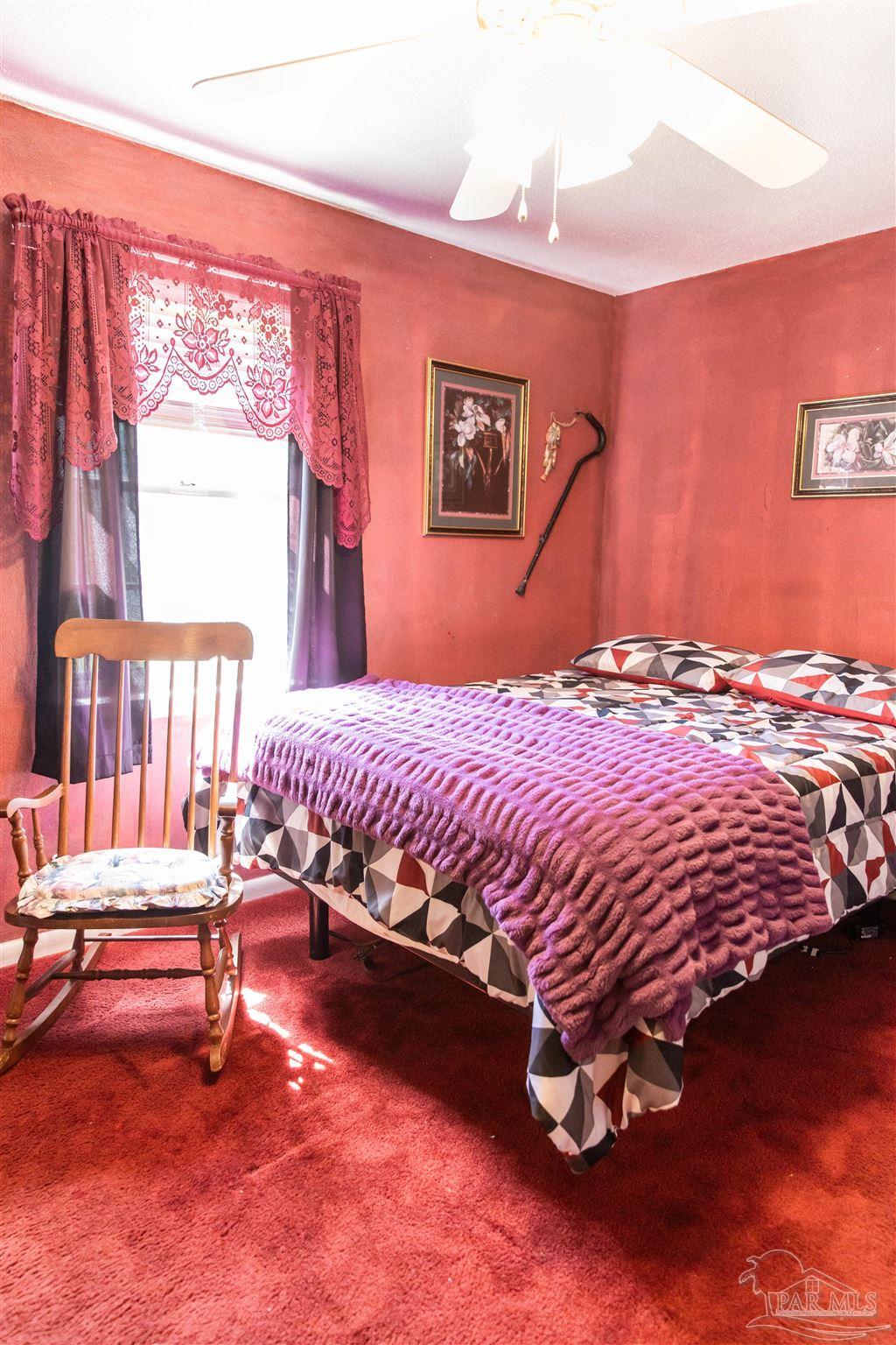 7569 Pine Meadows Loop Milton, FL 32571 - Photo 20 of 25 a bedroom with a bed and wooden floor