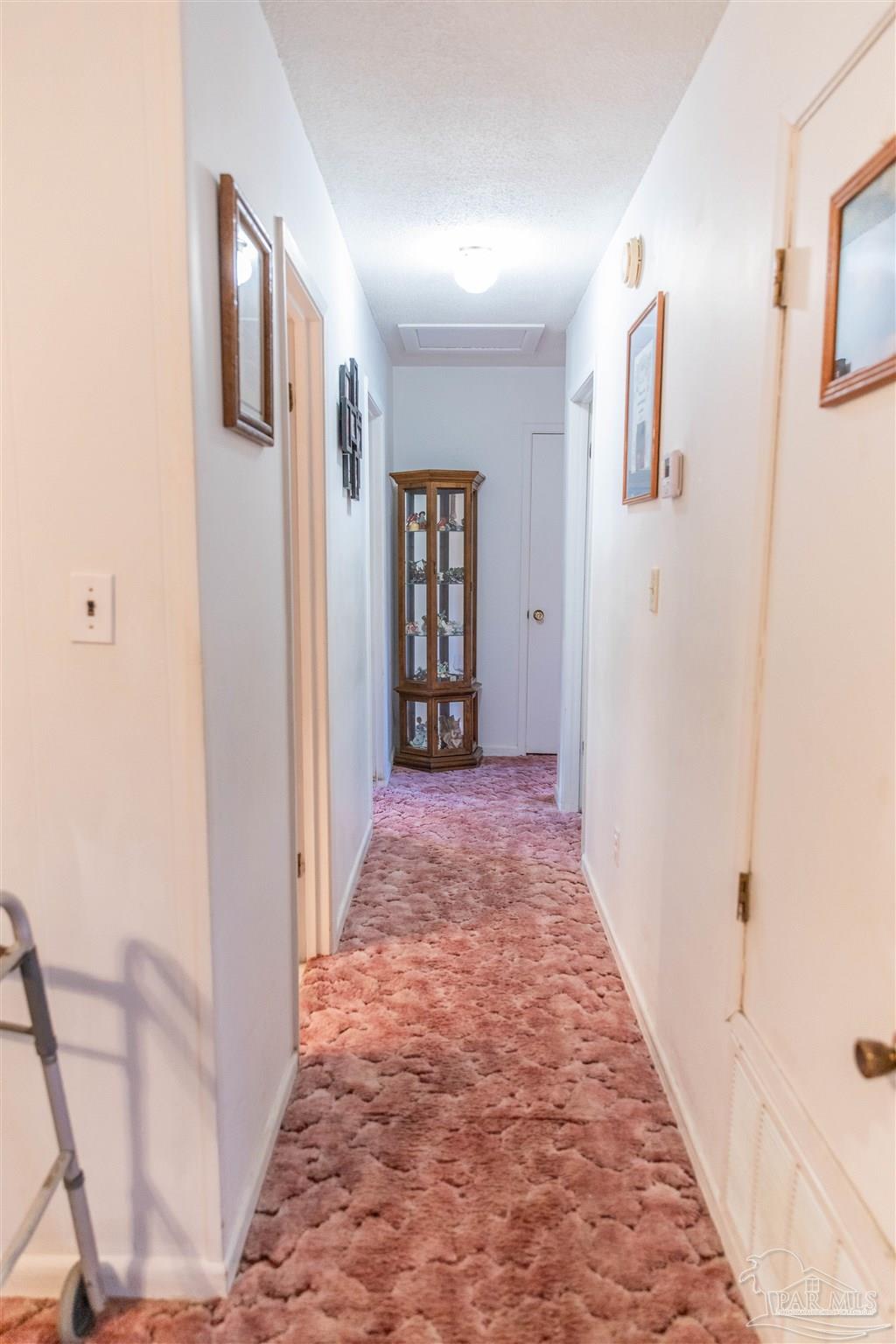 7569 Pine Meadows Loop Milton, FL 32571 - Photo 21 of 25 a view of a hallway with wooden floor and entryway