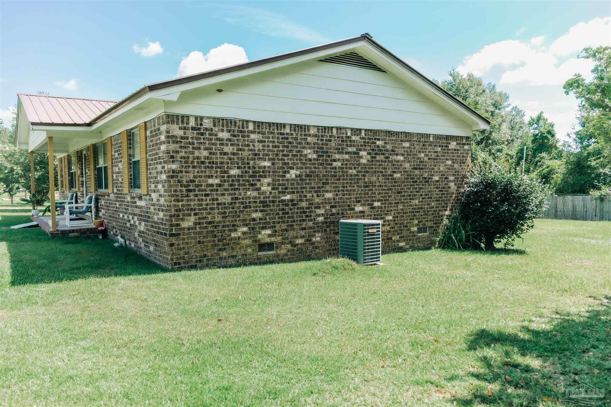 7569 Pine Meadows Loop Milton, FL 32571 - Photo 4 of 25 a view of a house with backyard and garden