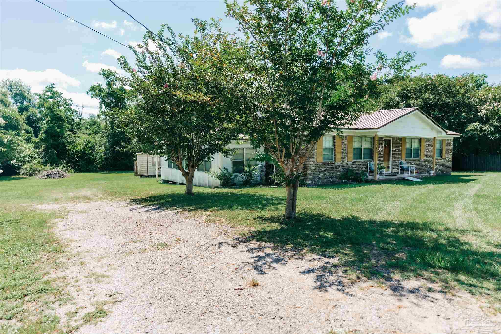7569 Pine Meadows Loop Milton, FL 32571 - Photo 7 of 25 a front view of a house with a yard