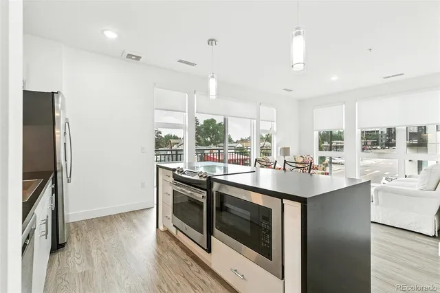 a kitchen with stainless steel appliances granite countertop a sink and stove top oven