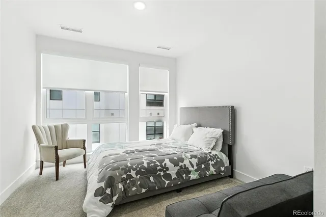 a bedroom with a bed and a chair