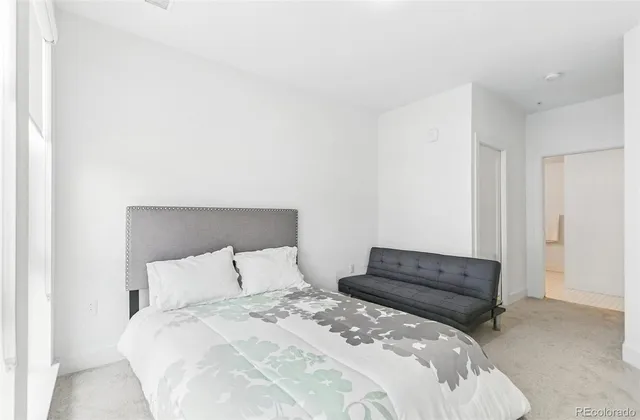 a bedroom with a bed and a couch