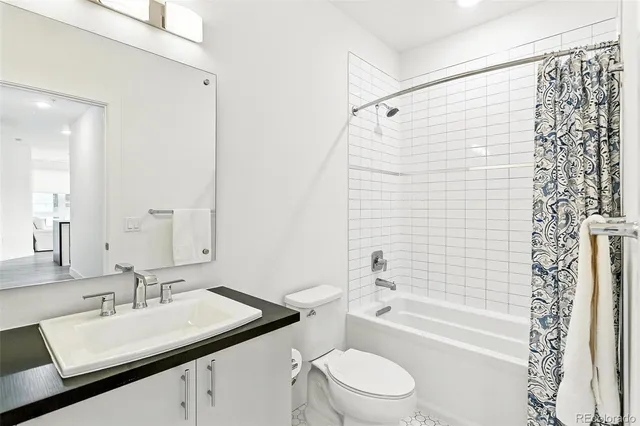 a bathroom with a sink toilet vanity and shower