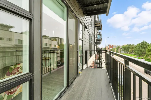 a view of a balcony with wooden floor and door