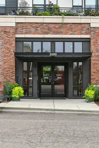 front view of a brick house with a small yard