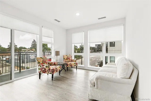 a living room with furniture and a large window with outer view