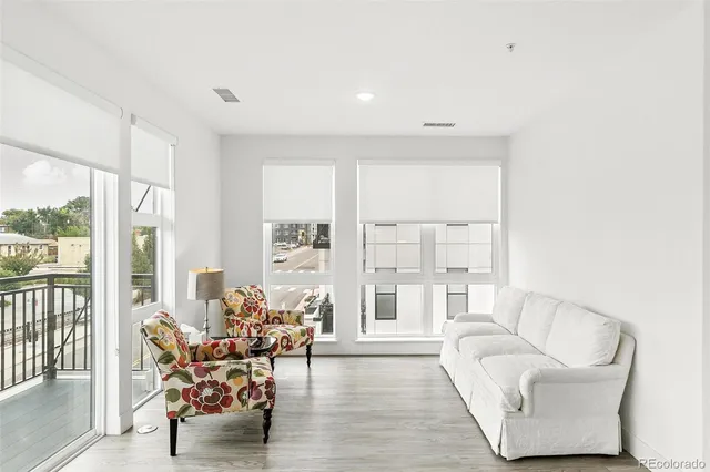 a living room with furniture and floor to ceiling windows