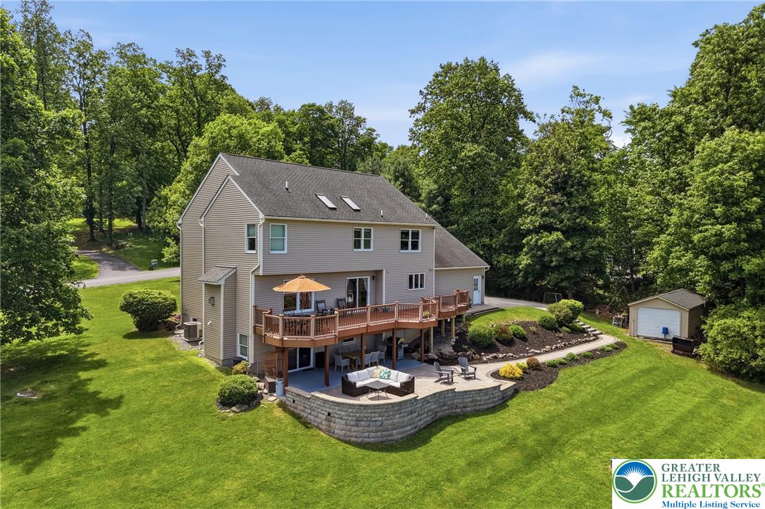 115 West Butternut Road Hellertown, PA 18055 - Photo 5 of 97 A spacious backyard with multiple decks, a patio, and abundant green space, perfect for outdoor living.
