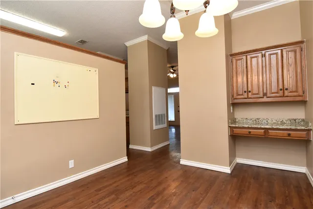 a view of a room with wooden floor and windows
