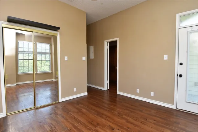 a view of a room with wooden floor and a window
