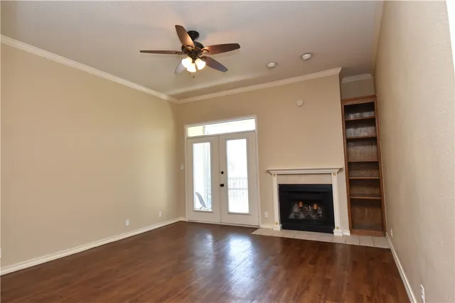 wooden floor in an empty room with a fireplace