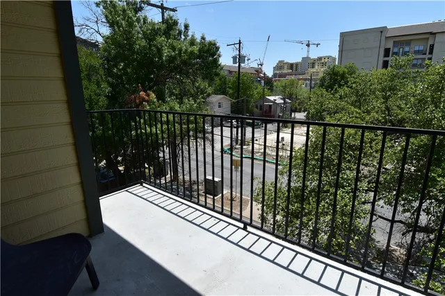 a view of a livingroom with wooden floor and a ceiling fan