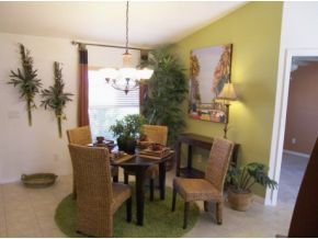 1010 Northeast Morgan Palm Bay, FL 32905 - Photo 6 of 12 a view of a dining room with furniture and a potted plant