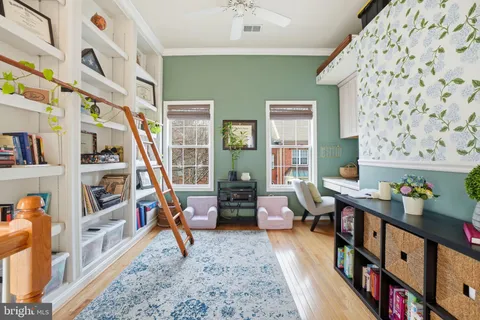 a bedroom with furniture and a book shelf