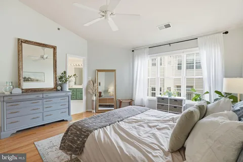 a bedroom with a bed table and window