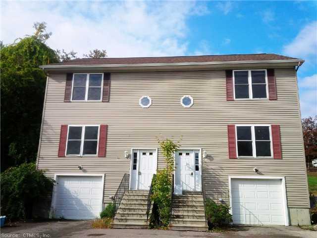 44 Pond Street, Unit 44 Sterling, CT 06377 - Photo 1 of 1 a front view of a house with a garden