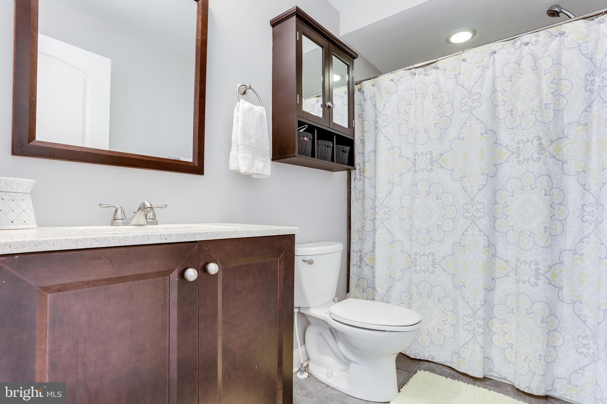 1809 Briarcliff Road Baltimore, MD 21234 - Photo 13 of 33 a bathroom with a sink a toilet and mirror