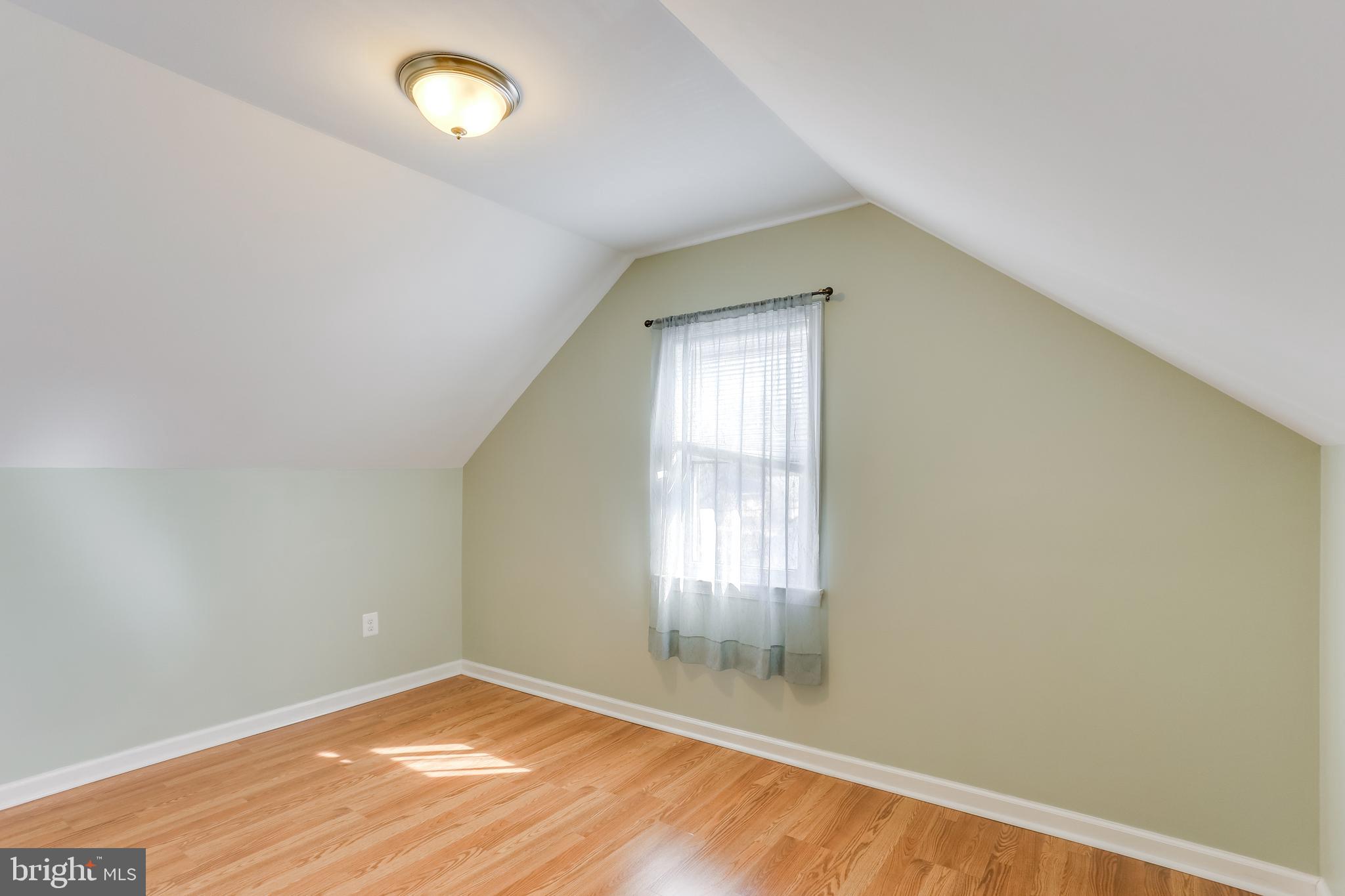 1809 Briarcliff Road Baltimore, MD 21234 - Photo 14 of 33 an empty room with wooden floor and windows